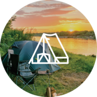 A tent set up viewing a sunset